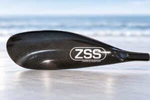 ZSS Genesis Evo paddle blade on a coastal background